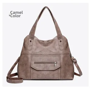 Detailed view of the camel PU leather tote bag with functional front zipper pocket