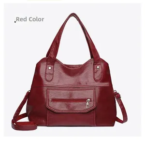 Detail view of red PU leather tote bag with lychee texture and silver hardware accents