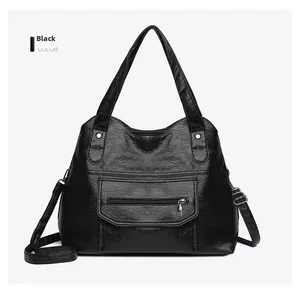 Front view of black soft PU leather tote bag with silver zippers and removable strap