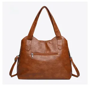 Rear view of brown large capacity tote bag featuring a practical zip pocket on back