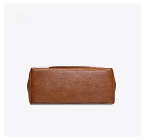 Detailed bottom view showing clean stitching and lychee grain texture of the brown tote