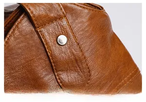 Macro shot of silver metal rivets and stitching on brown pebble-grain faux leather tote