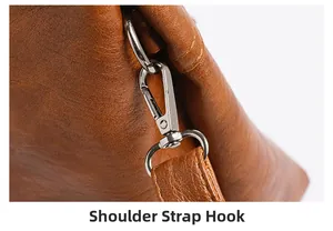 Macro detail of silver shoulder strap hook on brown pebbled leather tote bag