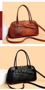 Detail of crocodile pattern texture and double zipper closure on handbags
