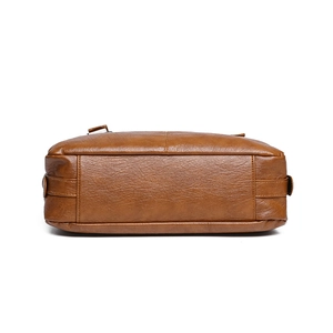 Bottom view of caramel brown leather tote bag featuring pebble texture and reinforced stitching
