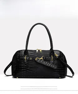 Front view of black faux crocodile leather handbag with gold zipper and hardware accents