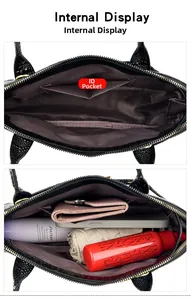 Interior view of crocodile embossed handbag showing spacious main compartment and pockets