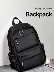 Detail of waterproof nylon black backpack with dual front zipper pockets on grey carpet