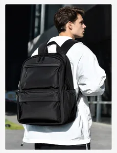 Detailed side view of the black backpack showing the side water bottle pocket and zippers