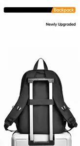 Detail of black nylon backpack featuring a functional luggage strap for travel