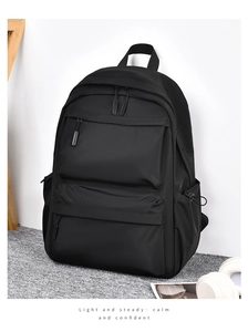Detail view of the black waterproof nylon backpack with multiple zippered storage pockets