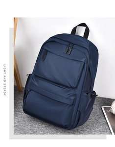 Detail view of large capacity navy blue backpack showing side profile and durable fabric