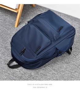 Top view of large dark blue nylon backpack featuring multiple compartments and side pockets