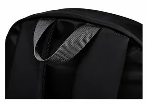 Detail of the reinforced top handle and padded shoulder strap on this black backpack