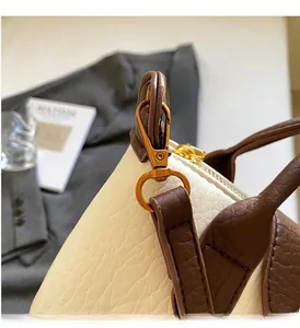 Detail of premium lychee texture leather and vintage bronze metal buckle on handbag