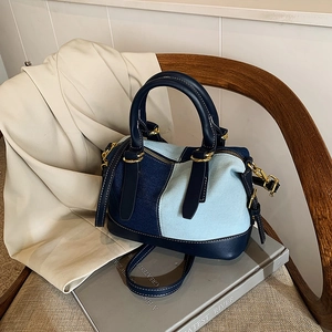 Contrast stitching denim Boston bag with leather handles and adjustable shoulder strap