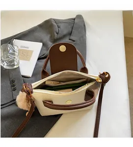 Detail view of the spacious inner compartment and light lining of the color-block bag