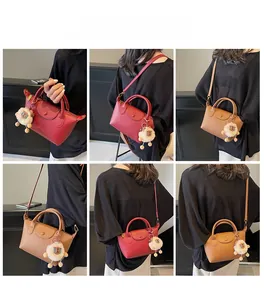 Multi-angle view of leather dumpling bag with plush sheep charm in red and brown colors