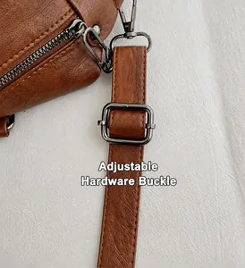 Detail of adjustable gunmetal hardware buckle and leather strap on a brown tote bag