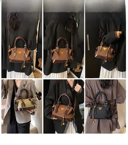 Detailansicht der Boston-Tasche mit glänzender PU-Lederstruktur und Metalllogo