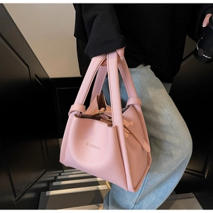 Detail of pink bucket bag featuring pebbled leather texture and HAMIROO logo branding