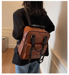 Classic brown vintage backpack on model showing large capacity and versatile styling