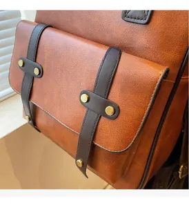 Detail of vintage caramel brown leather texture with brass hardware and strap buckle