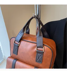 Detail of the reinforced leather handle and golden metal buckles on a vintage backpack