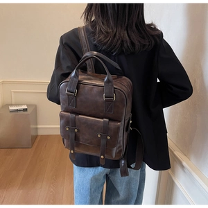 Deep brown retro style backpack for women shown in use, featuring vintage metal buckles