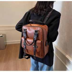 Classic brown leather backpack shown from a side view on model for everyday style