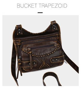 Macro detail of dark brown retro leather crossbody bag with metal zippers and studs