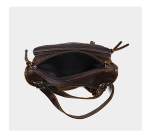 Close-up of vintage brown washed leather bag with multi-zipper detail and spacious interior