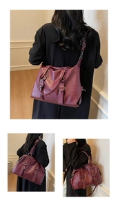 Detail of burgundy leather tote bag with silver buckles and adjustable shoulder straps