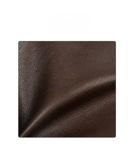 Detail of high quality dark brown faux leather with a soft lychee pattern texture