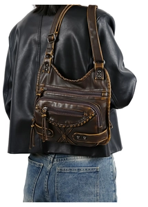 Close-up of vintage brown washed leather bag featuring distressed textures and metal rivets