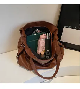 Spacious interior of dark brown pebbled leather tote bag showing large capacity for daily items
