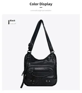 Detail of black washed leather crossbody bag with multiple zip pockets and rivet accents