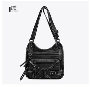 Close-up of a dark grey vintage multi-pocket shoulder bag with washed leather texture