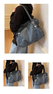 Detail of dark grey retro tote bag featuring silver hardware and textured leather finish