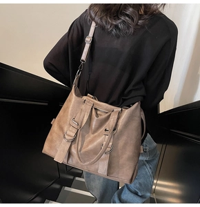 Macro shot showing textured faux leather and metal ring buckle on khaki tote bag