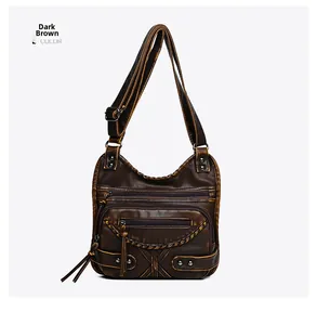 Detail of dark brown vintage crossbody bag with fringe zippers and woven texture