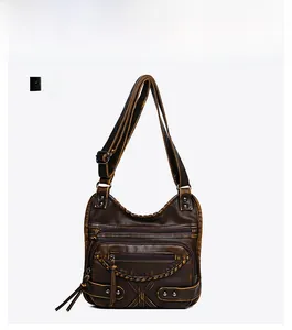 Front view of vintage crossbody bag with brown washed leather texture and rivet details