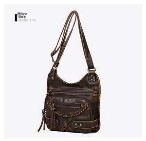Side view of retro brown washed leather crossbody bag with rivet details and tassels