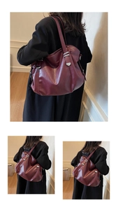 Macro detail of wine red pleated tote bag with silver buckle and leather texture