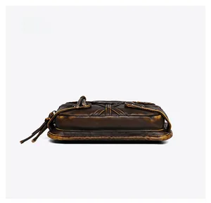 Detailed bottom view of vintage dark brown washed leather bag with visible thick hand stitching
