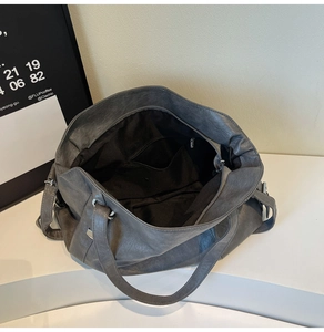 Top view of spacious grey tote interior featuring black lining and functional pockets