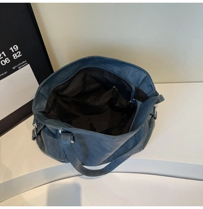 Top view of large dark blue tote bag showing interior lining and zipper pockets