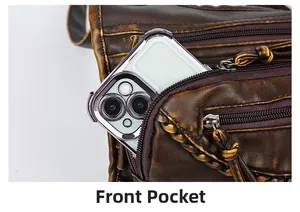 Front pocket of the vintage brown faux leather crossbody bag holding a smartphone