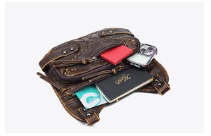 Detail view showing organized interior of vintage brown leather waist bag with phone storage
