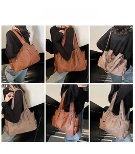 Detailed views of large shoulder tote bags with kangaroo logo on textured leather